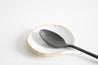 Handmade white speckled ceramic spoon rest by Mesh & Cloth